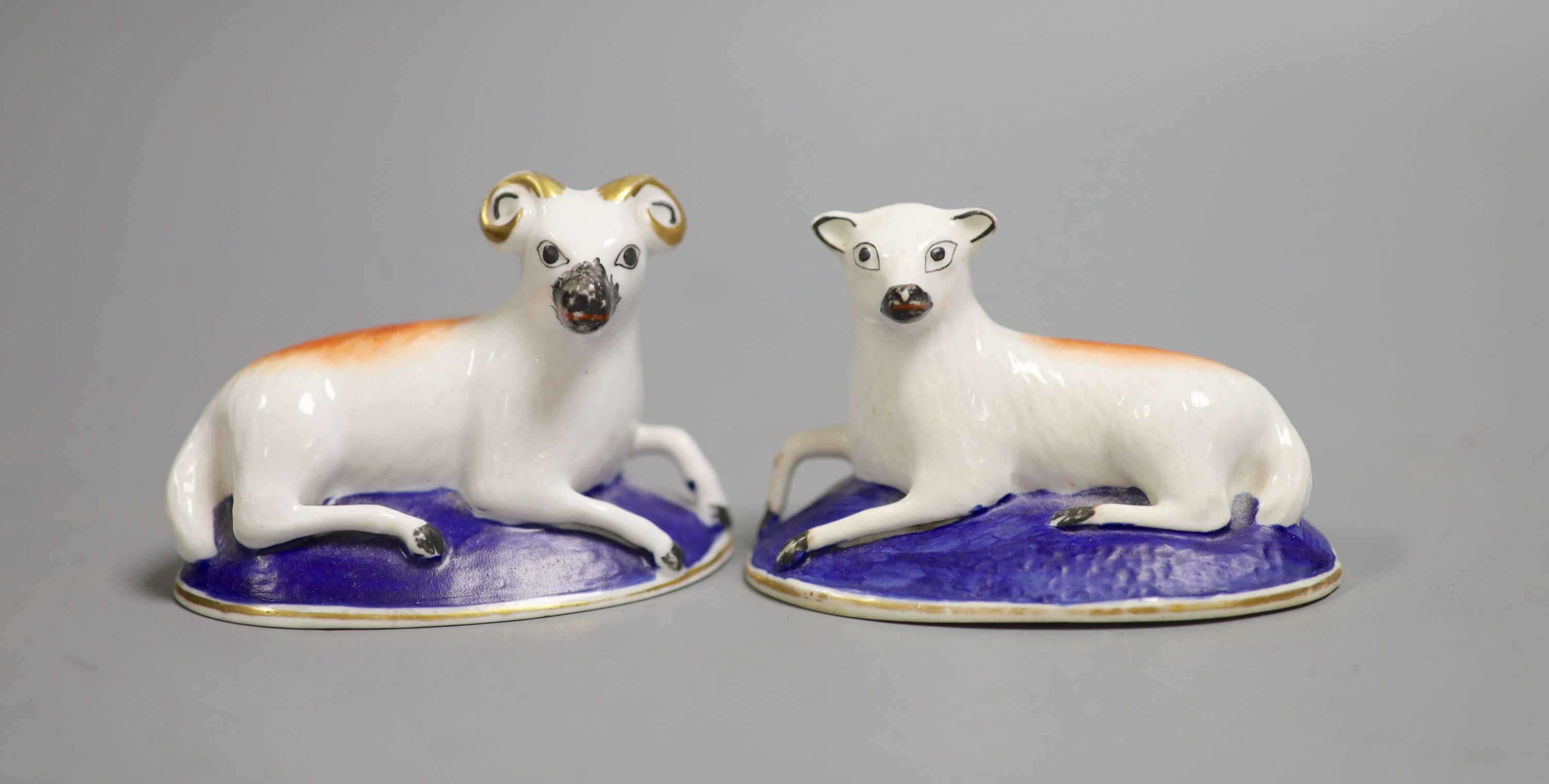 A rare pair of Charles Bourne models of a recumbent ram and a ewe, c.1817-30, iron red ‘4’, 8.5cm - 9cm